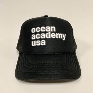 front view of ocean academy text on a mesh back foam trucker hat