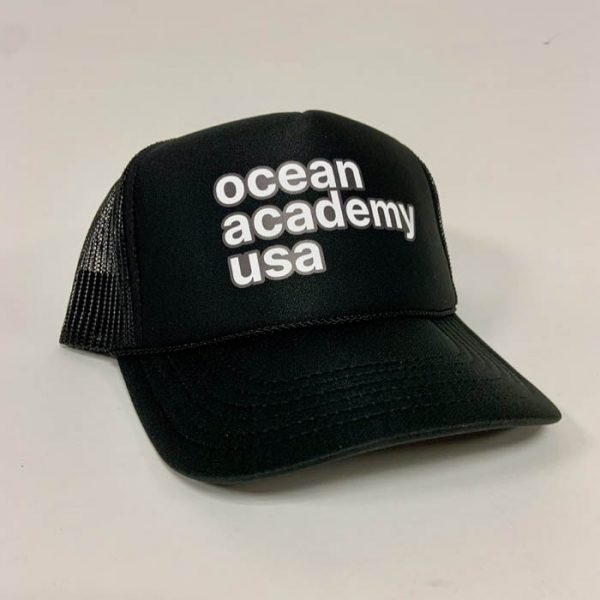 side view of ocean academy text on a mesh back foam trucker hat