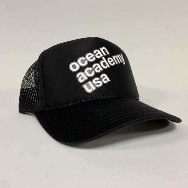 side view of ocean academy text angled on a mesh back foam trucker hat