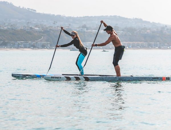 Candice working on paddling with athlete in the ocean